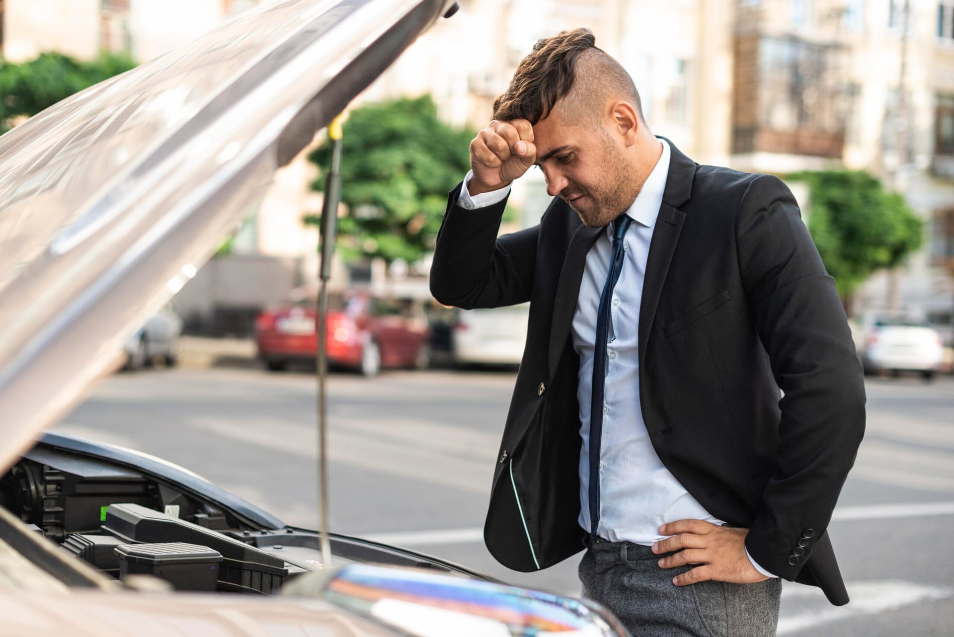 side view businessm man trying fix his car